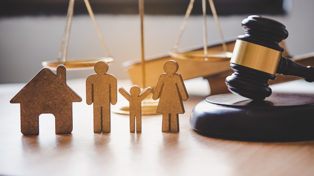 Wooden cutouts of a family next to a gavel