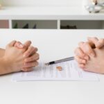 Couple going through divorce signing papers