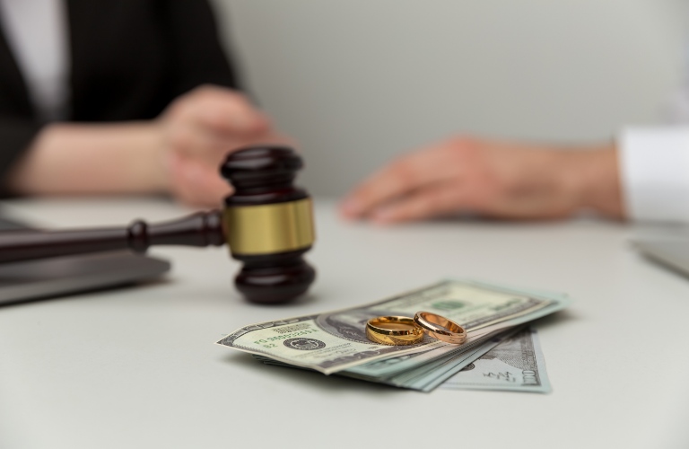 gavel with money and wedding rings
