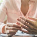 Woman in pink taking off her ring_s