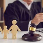 Judge sitting behind a gavel and a wooden family_s