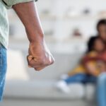 Man threatening wife and daughter with his fist_s
