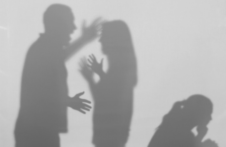 Silhouettes of quarreling parents and a small child on a white background