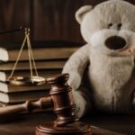 Wooden gavel and teddy bear_s