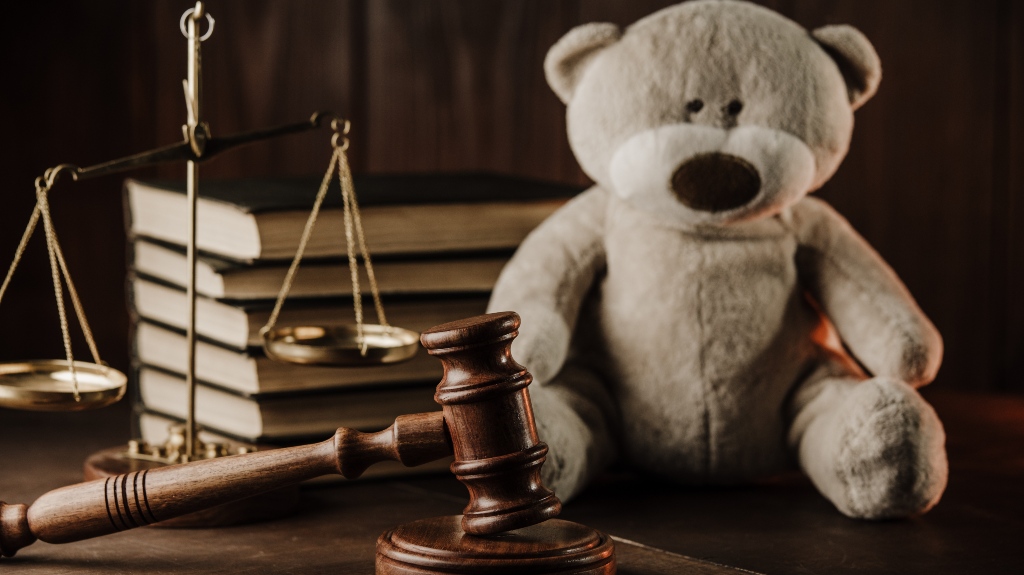 Wooden gavel and teddy bear