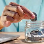 man is putting coins into a glass jar to prepare for retirement_s