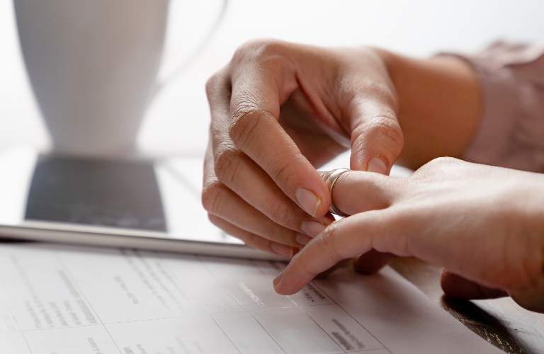 woman is removing wedding ring