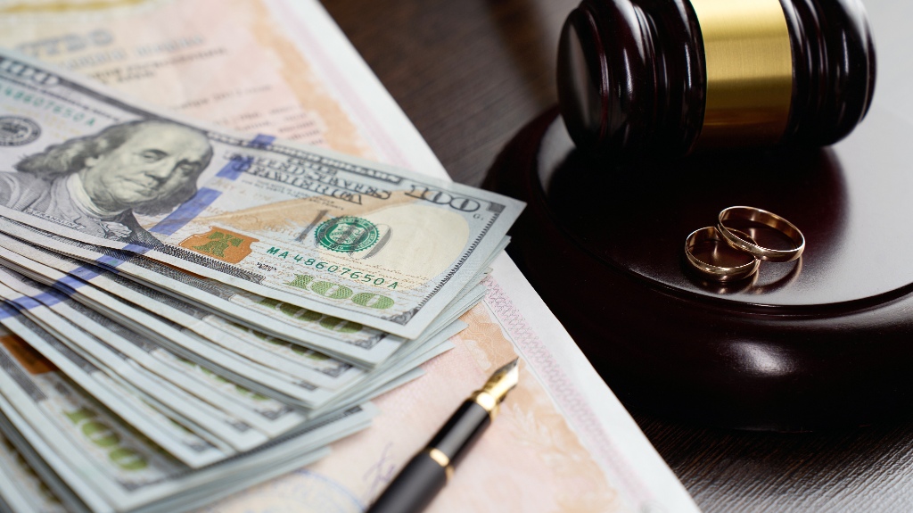 Wedding rings, judge gavel, dollar