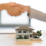 man and a woman shaking hands and house model_s