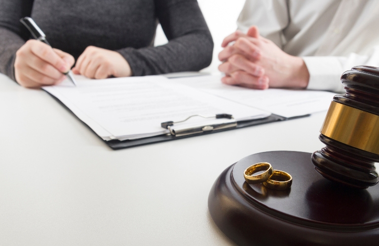 Hands of wife, husband signing decree of divorce