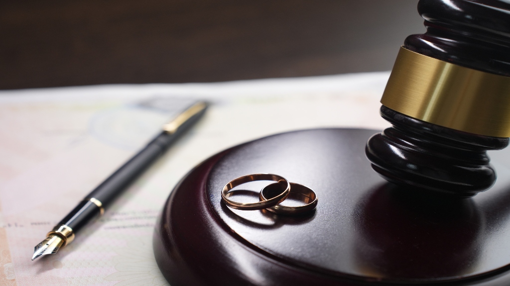 wedding bands and gavel on desk