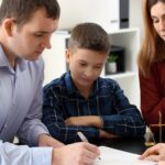 Divorced parents with their son visiting lawyer. Concept of child support_s