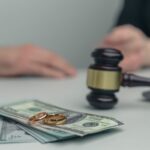Legal alimony concept. Closeup view of wooden gavel and money_s