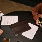 couple reviewing divorce papers and wedding rings_s